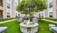 a courtyard with a fire pit, tables and chairs
