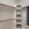 a closet with shelves and carpet