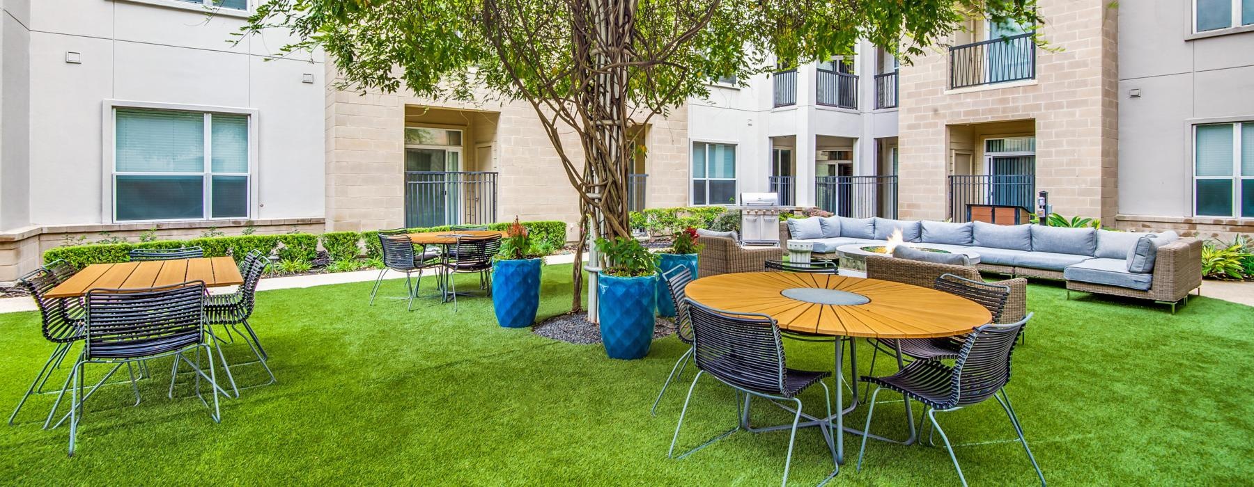 a courtyard with tables and chairs
