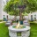 a courtyard with a fire pit, tables and chairs