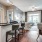 a kitchen with a bar and chairs